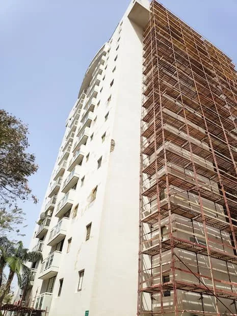 בניין עם פיגומים במהלך עבודות שיקום מעטפת והסרת צו מבנה מסוכן